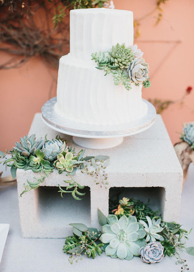 industrial wedding cake concrete display idea with cacti