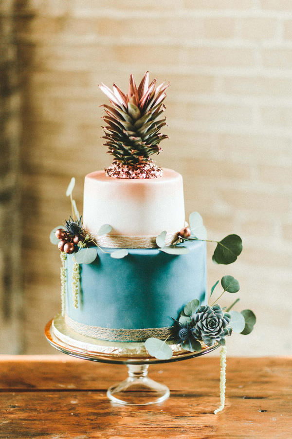 teal and copper wedding cake with pineapple topper